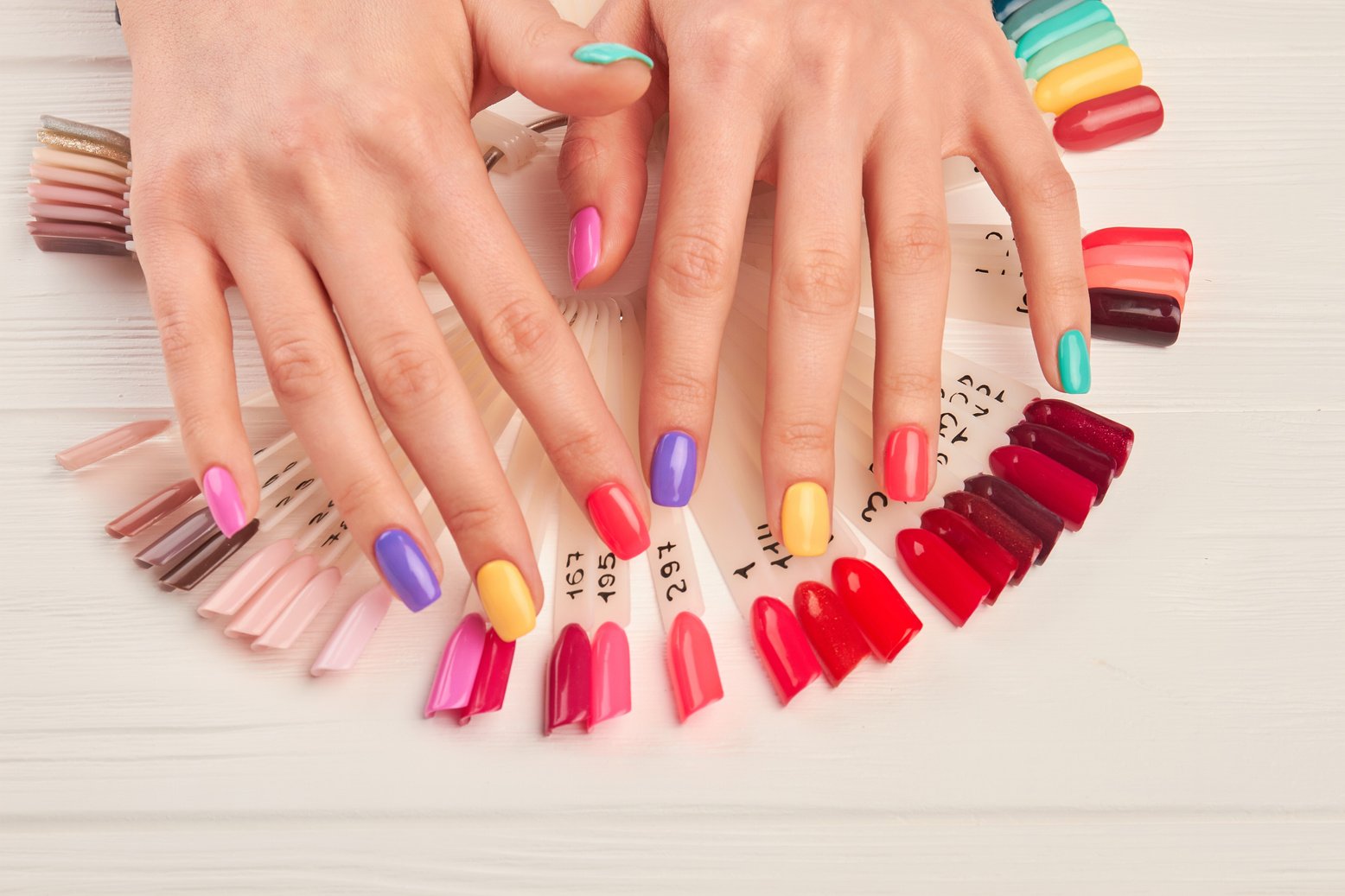 Hands with summer multicolored nails.